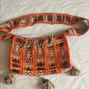 Vintage bohemian crossbody bag with tassels that zips up.